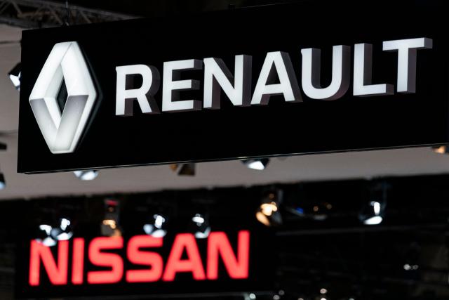 (FILES) Renault and Nissan automobile logos are pictured during the Brussels Motor Show on January 9, 2020 in Brussels. Renault expects Nissan's restructuring costs to have a negative impact of Ђ2.2 billion in the first quarter of 2025, the group announced on May 13, 2025. Japan's Nissan posted an annual net loss of $4.5 billion while saying it plans to cut 15 percent of its global workforce and warning about the possible impact of US tariffs. (Photo by Kenzo TRIBOUILLARD / AFP)