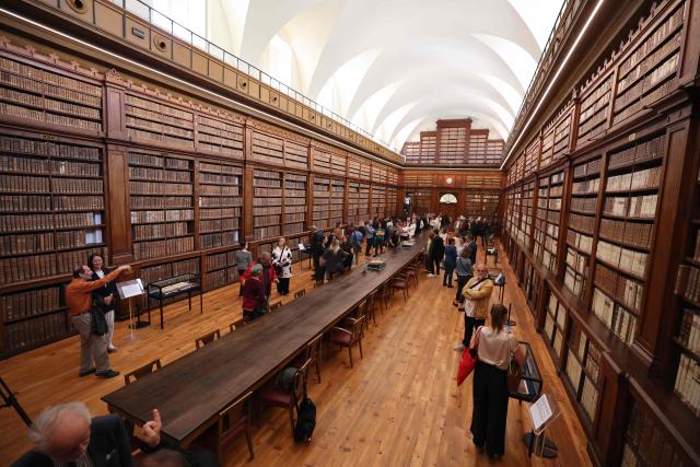 People visit the renovated Fesch municipal library during its re-opening inauguration in Ajaccio on the French Mediterranean island of Corsica, on May 13, 2025. (Photo by Pascal POCHARD-CASABIANCA / AFP)