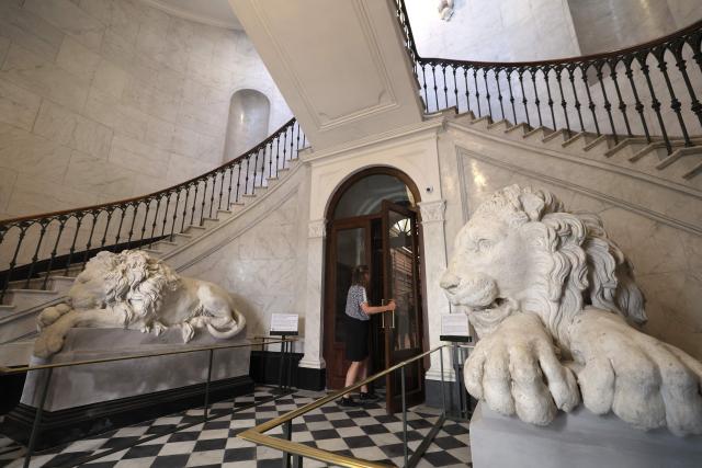 A person walks in the entrance hall of the renovated Fesch municipal library during its re-opening inauguration in Ajaccio on the French Mediterranean island of Corsica, on May 13, 2025. (Photo by Pascal POCHARD-CASABIANCA / AFP)