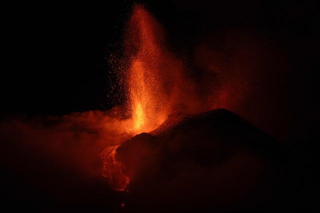 Lava flows during an eruption of the Mount Etna volcano, Sicily, late on May 12, 2025. (Photo by Marco RESTIVO / Etna Walk / AFP)
