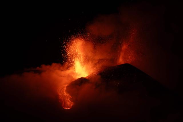 Lava flows during an eruption of the Mount Etna volcano, Sicily, late on May 12, 2025. (Photo by Marco RESTIVO / Etna Walk / AFP)