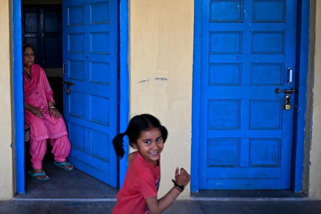 A woman temporarily displaced from her home at a border area, sits inside a room in an inn at a Gurudwara (Sikh temple), in Jammu on May 13, 2025. Indian and Pakistani military chiefs were set to confer on May 12 as a ceasefire that brought the nuclear-armed rivals back from the brink of all-out war held. Indian Prime Minister Narendra Modi vowed on May 12 to respond strongly to any future "terrorist attack", and warned that New Delhi would not tolerate "nuclear blackmail" in the event of further conflict with Pakistan. (Photo by Money SHARMA / AFP)