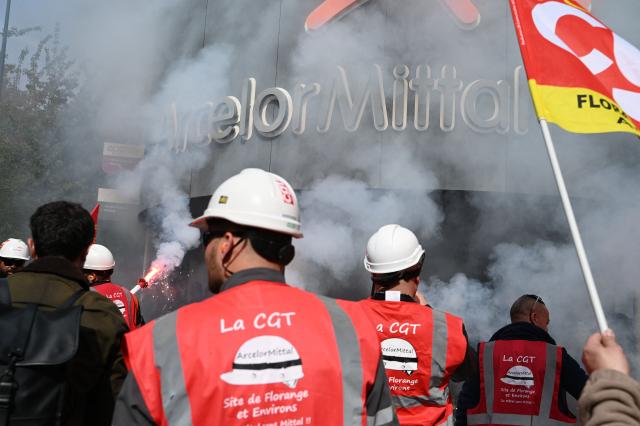 Employees take part in a rally outside ArcelorMittal headquarters to put pressure on the French management of the steelmaker, which is planning to cut more than 600 jobs in Saint-Denis near Paris, on May 13, 2025. (Photo by LEO VIGNAL / AFP)