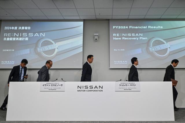 Executives from Japanese automaker Nissan leave at the end of a press conference to announce the company's fiscal 2024 full-year results, at their headquarters in the city of Yokohama, Kanagawa prefecture on May 13, 2025. Japanese automaker Nissan posted a huge annual net loss of 4.5 billion USD on May 13, while confirming reports that it planned to cut 20,000 jobs worldwide. (Photo by Richard A. Brooks / AFP)