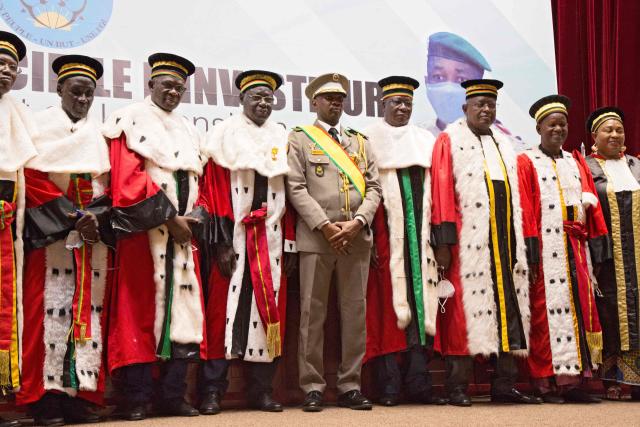 (FILES) New interim Malian President, Colonel Assimi Goita (C), stands with members of the Supreme Court during his swearing in ceremony in Bamako on June 7, 2021. Mali's military ruler on on May 13, 2025 approved a bill revoking the country's political parties charter, which the opposition sees as a step towards its dissolution, according to a presidency decree.
The suspension of the charter, which regulates the functioning, creation and financing of political parties, marks a new act of repression of dissenting voices in the west African country, ruled by the army since two coups, in 2020 and 2021. (Photo by ANNIE RISEMBERG / AFP)