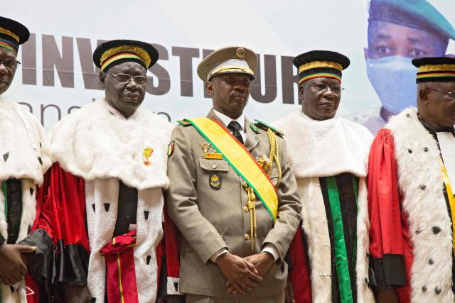 (FILES) New interim Malian President, Colonel Assimi Goita (C), stands with members of the Supreme Court during his swearing in ceremony in Bamako on June 7, 2021. Mali's military ruler on on May 13, 2025 approved a bill revoking the country's political parties charter, which the opposition sees as a step towards its dissolution, according to a presidency decree.
The suspension of the charter, which regulates the functioning, creation and financing of political parties, marks a new act of repression of dissenting voices in the west African country, ruled by the army since two coups, in 2020 and 2021. (Photo by ANNIE RISEMBERG / AFP)