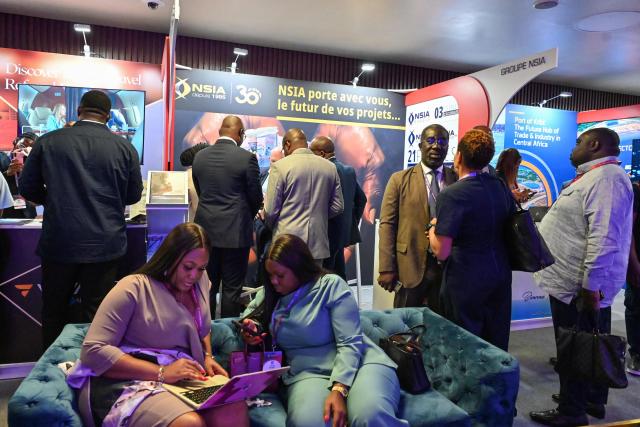 Attendees talk between sessions on the second day of the Africa CEO Forum annual summit in Abidjan on May 13, 2025. (Photo by Issouf SANOGO / AFP)