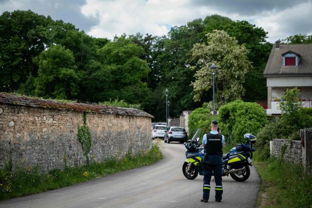 A gendarme stands guard to block access to the permiter near a construction work site following the collapse of a stone wall that killed three workers, in Pommard, central-eastern France, on May 13, 2025. Three workers, men aged 45, 56 and 58, were killed when an old stone wall collapsed while working on the site of a farm building in the small wine-producing village in the Cote d'Or region, sources said. (Photo by ARNAUD FINISTRE / AFP)