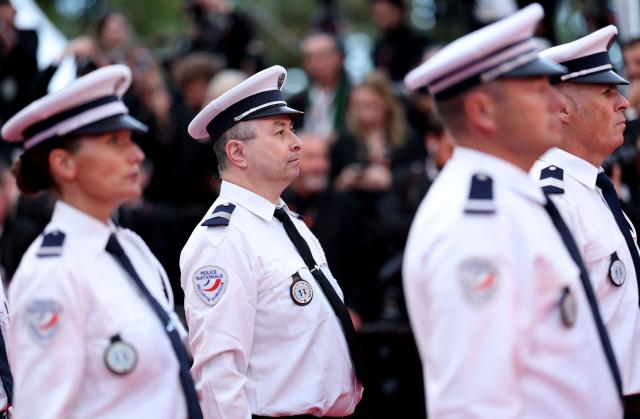 French Police Nationale officers stand in position before the start of the Opening Ceremony and the screening of the film "Partir un Jour" (Bye Bye) presented out of competition at the 78th edition of the Cannes Film Festival in Cannes, southern France, on May 13, 2025. (Photo by Sameer AL-DOUMY / AFP)