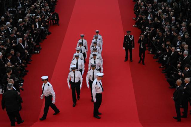 French Police Nationale officers stand in position before the start of the Opening Ceremony and the screening of the film "Partir un Jour" (Bye Bye) presented out of competition at the 78th edition of the Cannes Film Festival in Cannes, southern France, on May 13, 2025. (Photo by Antonin THUILLIER / AFP)