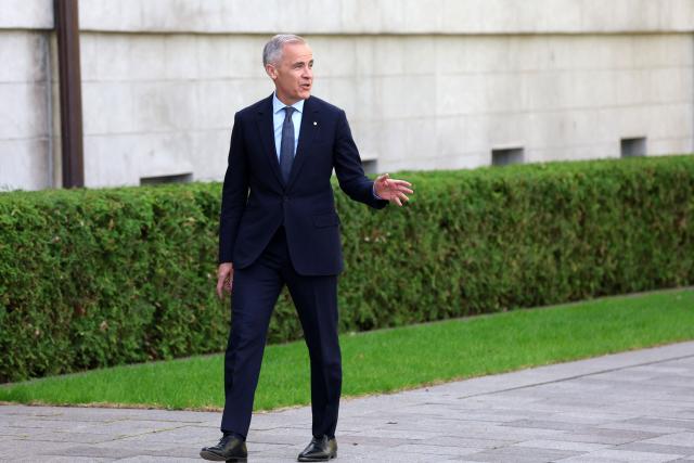 Canadian Prime Minister Mark Carney arrives at a swearing-in ceremony for members of the Canadian ministry at Rideau Hall in Ottawa, Ontario, Canada, May 13, 2025. Carney and his team will have two weeks to prepare for a new session of parliament, which will be opened by King Charles. Carney's Liberals fell just short of the 172 seats needed for majority control of Parliament, but with 169 confirmed wins they will be in a strong position to pass legislation. (Photo by Dave Chan / AFP)