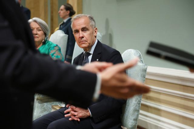 Canadian Prime Minister Mark Carney attends a swearing-in ceremony for members of the Canadian ministry at Rideau Hall in Ottawa, Ontario, Canada, May 13, 2025. Carney and his team will have two weeks to prepare for a new session of parliament, which will be opened by King Charles. Carney's Liberals fell just short of the 172 seats needed for majority control of Parliament, but with 169 confirmed wins they will be in a strong position to pass legislation. (Photo by Dave Chan / AFP)