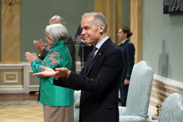 Canadian Prime Minister Mark Carney attends a swearing-in ceremony for members of the Canadian ministry at Rideau Hall in Ottawa, Ontario, Canada, May 13, 2025. Carney and his team will have two weeks to prepare for a new session of parliament, which will be opened by King Charles. Carney's Liberals fell just short of the 172 seats needed for majority control of Parliament, but with 169 confirmed wins they will be in a strong position to pass legislation. (Photo by Dave Chan / AFP)