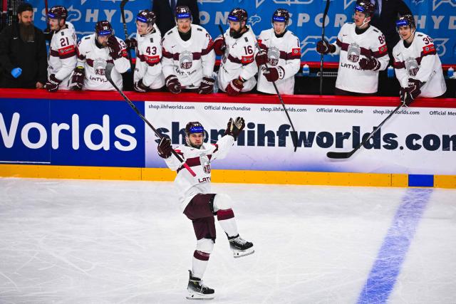 Latvia’s forward #17 Martins Dzierkals celebrates after scoring the 1-3 goal during the IIHF Men's Ice hockey World Championship match between Slovenia and Latvia in Stockholm, on May 13, 2025. (Photo by Jonathan NACKSTRAND / AFP)