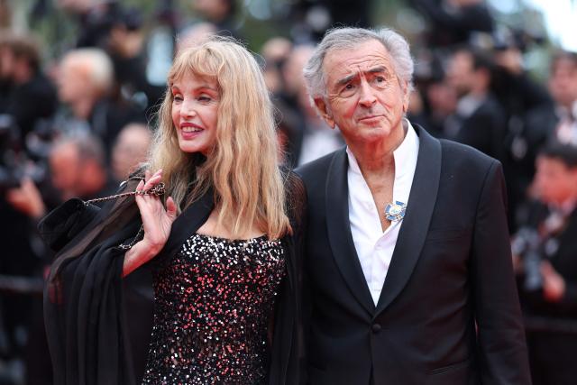 US-born French actress, singer, director and model Arielle Dombasle and her husband French philosopher Bernard-Henri Levy arrive for the Opening Ceremony and the screening of the film "Partir un Jour" (Bye Bye) presented out of competition at the 78th edition of the Cannes Film Festival in Cannes, southern France, on May 13, 2025. (Photo by Sameer AL-DOUMY / AFP)
