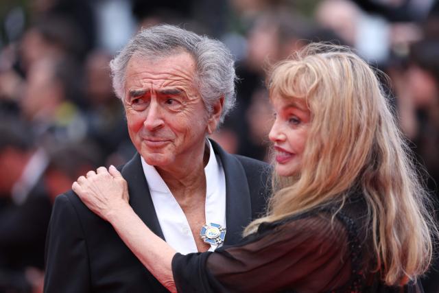 US-born French actress, singer, director and model Arielle Dombasle and her husband French philosopher Bernard-Henri Levy arrive for the Opening Ceremony and the screening of the film "Partir un Jour" (Bye Bye) presented out of competition at the 78th edition of the Cannes Film Festival in Cannes, southern France, on May 13, 2025. (Photo by Sameer AL-DOUMY / AFP)
