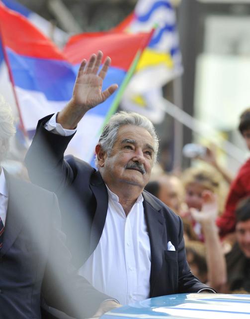 (FILES) Newly sworn-in Uruguayan President Jose Mujica waves to the crowd in the streets of Montevideo on the day of his inauguration on March 1, 2010. Uruguay's former president (2010-2015) Jose "Pepe" Mujica, a former guerrilla fighter and icon of the left in Latin America, died at the age of 89 on May 13, 2025, the government announced. The farmer dubbed the "world's poorest president" during his presidency for his modest lifestyle had been diagnosed with cancer of the esophagus in May 2024. (Photo by Pablo PORCIUNCULA / AFP)