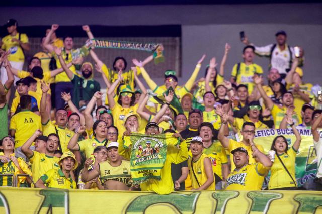 Fans of Bucaramanga cheer for their team ahead of the Copa Libertadores group stage football match between Brazil's Fortaleza and Colombia's Atletico Bucaramanga, at the Arena Castelao stadium in Fortaleza, state of Ceara, Brazil, on May 13, 2025. (Photo by Thiago GADELHA / AFP)