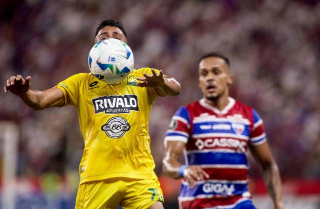 Bucaramanga's forward #70 Frank Castaneda (L) controls the ball past Fortaleza's defender #06 Bruno Pacheco during the Copa Libertadores group stage football match between Brazil's Fortaleza and Colombia's Atletico Bucaramanga, at the Arena Castelao stadium in Fortaleza, state of Ceara, Brazil, on May 13, 2025. (Photo by Thiago GADELHA / AFP)