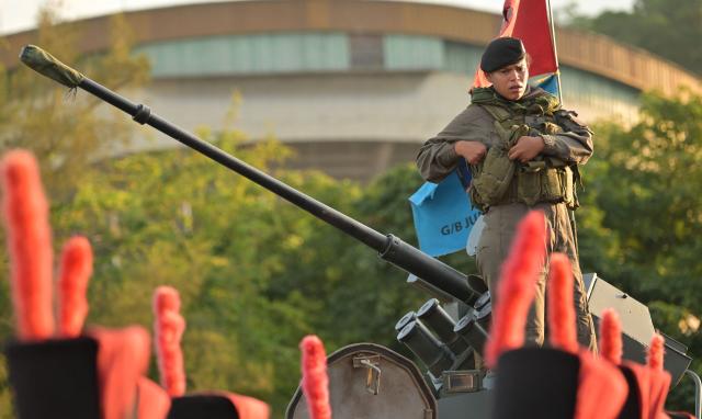 A member of the Venezuelan Army stands on a tank during a military parade at the inauguration of Victory Square, commemorating the 80th anniversary of the Soviet Union's victory over Nazi Germany in World War Two (WWII), in Caracas on May, 13, 2025. (Photo by Juan BARRETO / AFP)