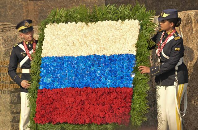 Members of the Venezuelan Army hold wreath in the colors of the Russian flag at a military parade during the inauguration of Victory Square, commemorating the 80th anniversary of the Soviet Union's victory over Nazi Germany in World War Two (WWII), in Caracas on May, 13, 2025. (Photo by Juan BARRETO / AFP)