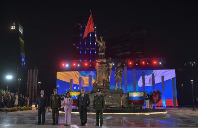 Venezuela's Vice-President Delcy Rodriguez (C) speaks next to Venezuela's Interior Minister Diosdado Cabello(L), Venezuelan Defense Minister Gen. Vladimir Padrino Lopez(2-L) and Russian ambassador Sergey Mélik-Bagdasárov (2-R) during a military parade at the inauguration of Victory Square, commemorating the 80th anniversary of the Soviet Union's victory over Nazi Germany in World War Two (WWII), in Caracas on May, 13, 2025. (Photo by Juan BARRETO / AFP)