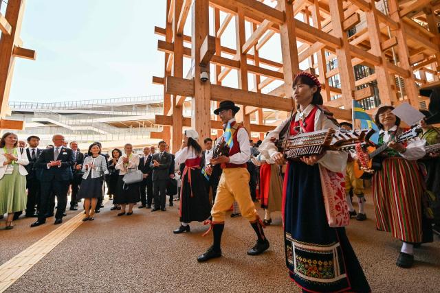 Sweden's King Carl XVI Gustaf (2nd L-front) and Japan's Princess Akiko of Mikasa (3rd L-front) watch a parade pass by during ceremonies to mark Sweden's National Day during his visit to the 2025 Osaka Expo in Osaka on May 14, 2025. (Photo by Richard A. Brooks / AFP)