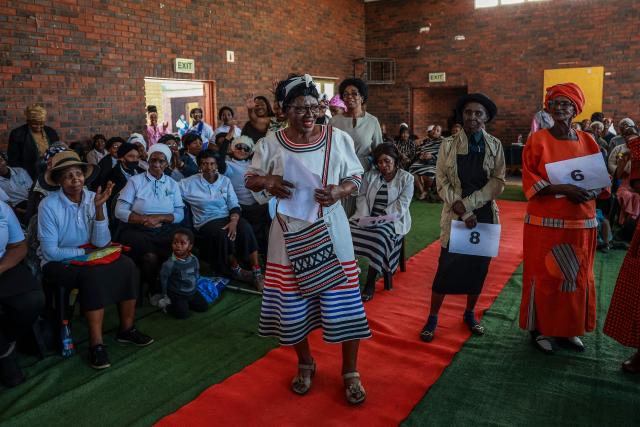 Margaret Fatyela (C), 78, reacts after being announced as the overall winner of the Sukuma Mbokodo Support Group’s Elderly Beauty Contest in Thokoza on May 13, 2025. (Photo by Phill Magakoe / AFP)