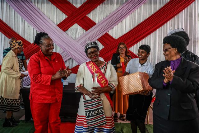 Margaret Fatyela (C), 78, reacts after being crowned the winner of the Sukuma Mbokodo Support Group’s Elderly Beauty Contest in Thokoza on May 13, 2025. (Photo by Phill Magakoe / AFP)