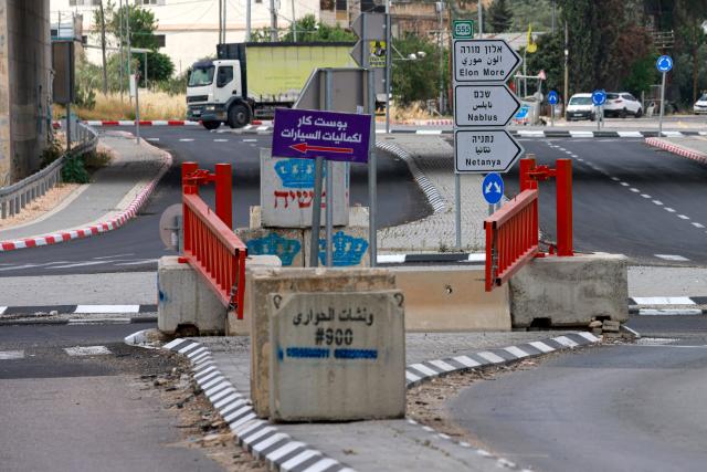 This picture shows an metal gate set up by the Israeli army in Hawara, in the occupied West Bank, on May 12, 2025. Israel heavily restricts the movement of West Bank Palestinians, who must obtain permits from authorities to travel through checkpoints and cross into east Jerusalem or Israel. (Photo by Jaafar ASHTIYEH / AFP)
