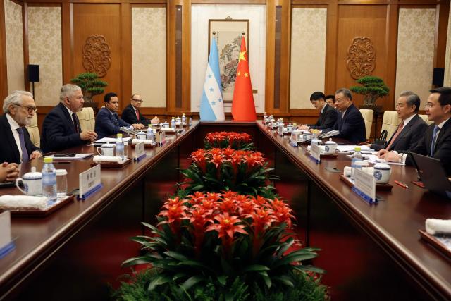 Chinese Foreign Minister Wang Yi (2nd-R) and Honduras Foreign Minister Eduardo Enrique Reina (2nd-L) attend a meeting at the Diaoyutai State Guesthouse in Beijing on May 14, 2025. (Photo by FLORENCE LO / POOL / AFP)
