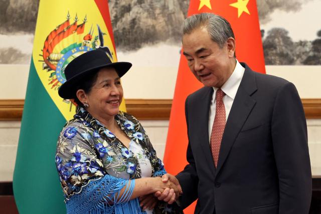 Chinese Foreign Minister Wang Yi (R) and Bolivia's Foreign Minister Celinda Sosa Lunda shake hands before their meeting at the Diaoyutai State Guesthouse in Beijing on May 14, 2025. (Photo by FLORENCE LO / POOL / AFP)