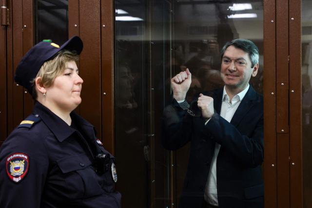 Grigory Melkonyants, the co-chair of independent Russian election monitoring group Golos, accused of cooperation with an "undesirable" organisation, reacts inside the glass defendants' box during the verdict announcement at the Basmanny district court in Moscow on May 14, 2025. (Photo by STRINGER / AFP)