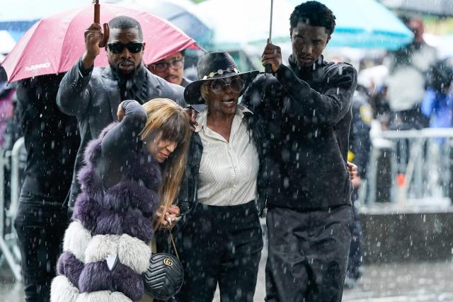 TOPSHOT - King Combs (R), son of Sean Combs, holds an umbrella for Janice Combs, mother of Sean Combs, as they arrive at federal court for Sean "Diddy" Combs' sex trafficking trial in New York City on May 14, 2025. Sean "Diddy" Combs used violence and threats of reputational ruin to control women he abused for years, New York jurors heard May 12 during opening statements of the federal sex trafficking trial that was followed by the case's intitial graphic testimonies. The panel of 12 jurors and six alternates responsible for determining Combs's fate heard of the famed artist's explosive outbursts and an attempt to preserve his own reputation and power of celebrity through bribery. (Photo by TIMOTHY A. CLARY / AFP)