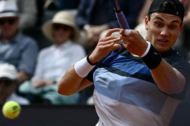 Great Britain's Jack Draper returns a shot to Spain's Carlos Alcaraz during their men's singles match at the ATP Rome Open tennis tournament at Foro Italico in Rome on May 14, 2025. (Photo by Filippo MONTEFORTE / AFP)