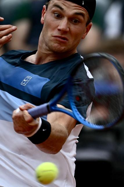 Great Britain's Jack Draper returns a shot to Spain's Carlos Alcaraz during their men's singles match at the ATP Rome Open tennis tournament at Foro Italico in Rome on May 14, 2025. (Photo by Filippo MONTEFORTE / AFP)