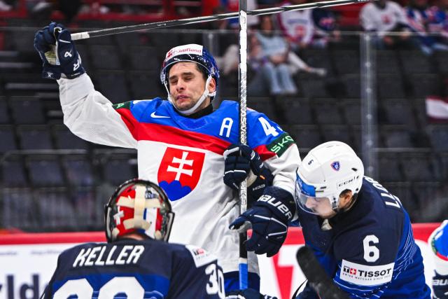Slovakia’s forward #49 Samuel Takac vies with France’s defender #6 Vincent Llorca during the IIHF Men's Ice hockey World Championship match between Slovakia and France in Stockholm, on May 14, 2025. (Photo by Jonathan NACKSTRAND / AFP)