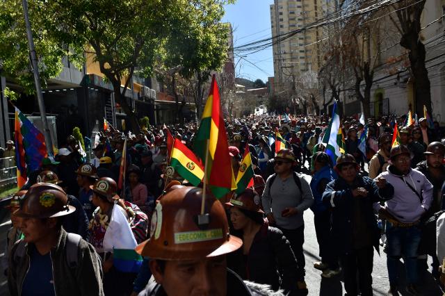 Supporters of Bolivia's former president Evo Morales try to reach the Supreme Electoral Tribunal to demand the registration of their leader as a presidential candidate in La Paz on May 16, 2025. (Photo by JORGE BERNAL / AFP)