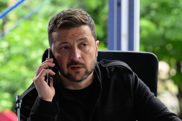 Ukraine's President Volodymyr Zelensky speaks on the phone during a meeting as part of the European Political Community (EPC) summit, in Tirana on May 16, 2025. (Photo by Leon Neal / POOL / AFP)