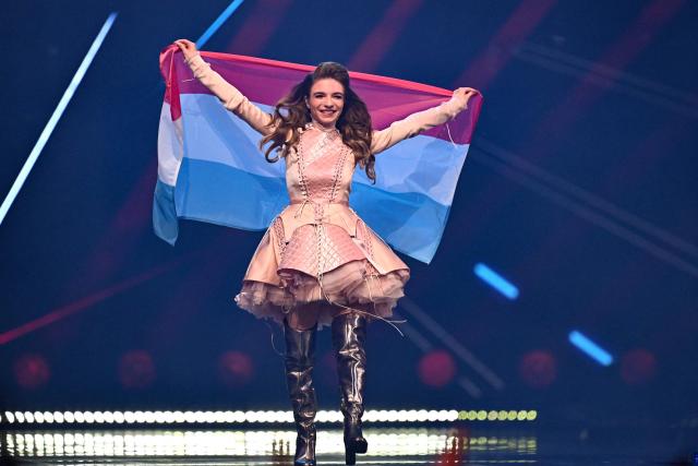 Luxembourg singer Laura Thorn, representing Luxembourg with the song “La Poupee Monte Le Son”, parades with her national flag during the dress rehearsal for the final of the Eurovision Song Contest 2025 at the St. Jakobshalle arena in Basel on May 16, 2025. (Photo by Fabrice COFFRINI / AFP)