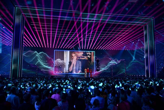 A giant screen shows Canadian singer Celine Dion giving a recorded message during the dress rehearsal for the final of the Eurovision Song Contest 2025 at the St. Jakobshalle arena in Basel on May 16, 2025. Dion was 20 and little-known outside her native French-speaking Quebec province in Canada when she won Eurovision in 1988, guesting for Switzerland, with the song "Ne Partez Pas Sans Moi". (Photo by Fabrice COFFRINI / AFP)