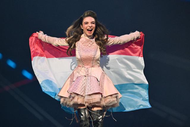 Luxembourg singer Laura Thorn, representing Luxembourg with the song “La Poupee Monte Le Son”, parades with her national flag during the dress rehearsal for the final of the Eurovision Song Contest 2025 at the St. Jakobshalle arena in Basel on May 16, 2025. (Photo by Fabrice COFFRINI / AFP)