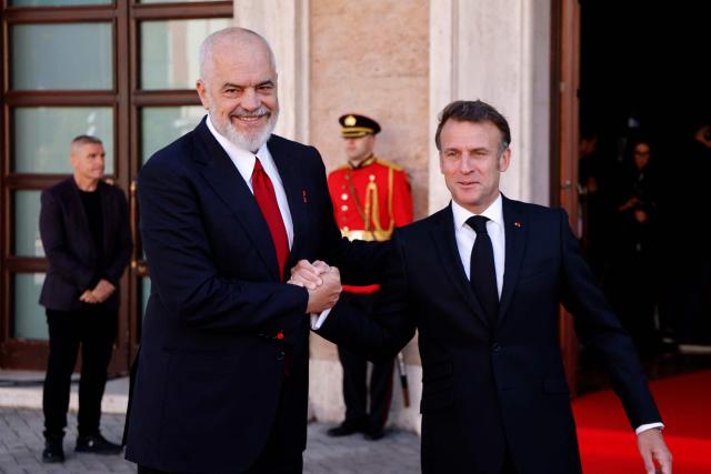 Albania's Prime Minister Edi Rama (L) shakes hands with France's President Emmanuel Macron at the Presidential Palace, in Tirana on May 17, 2025. (Photo by Ludovic MARIN / AFP)