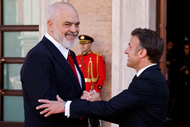 Albania's Prime Minister Edi Rama (L) shakes hands with France's President Emmanuel Macron at the Presidential Palace, in Tirana on May 17, 2025. (Photo by Ludovic MARIN / AFP)