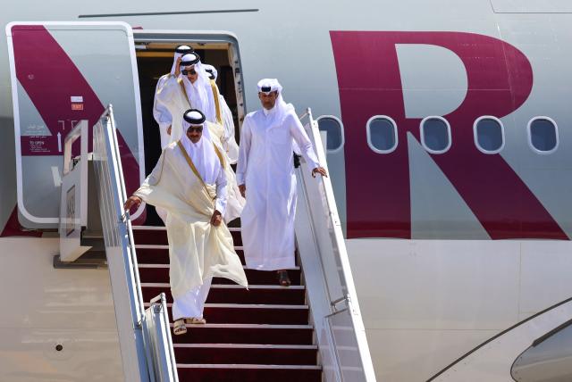 Qatar's Emir Sheikh Tamim bin Hamad al-Thani arrives in Iraq's Baghdad international airport ahead of the 34th Arab League summit on May 17, 2025. (Photo by AHMAD AL-RUBAYE / POOL / AFP)