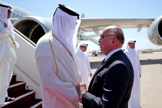 Iraq's Foreign Minister Fuad Hussein (R) welcomes Qatar's Emir Sheikh Tamim bin Hamad al-Thani as he arrives in Baghdad ahead of the 34th Arab League summit on May 17, 2025. (Photo by Murtadha AL-SUDANI / POOL / AFP)