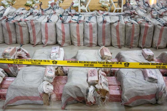 Part of packages of 705 kg methamphetamine and 1.2 tonnes of cocaine seized from a Thai fishing boat during a presser at a naval base in Batam, Riau Islands on May 17, 2025. (Photo by Andaru AK / AFP)