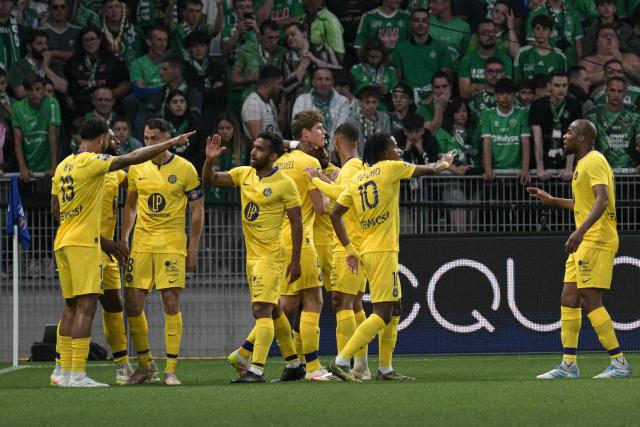 Toulouse's players celebrate after scoring a goal during the French L1 football match between AS Saint-Etienne and Toulouse FC at the Geoffroy-Guichard Stadium in Saint-Etienne, central France, on May 17, 2025. (Photo by JEAN-PHILIPPE KSIAZEK / AFP)