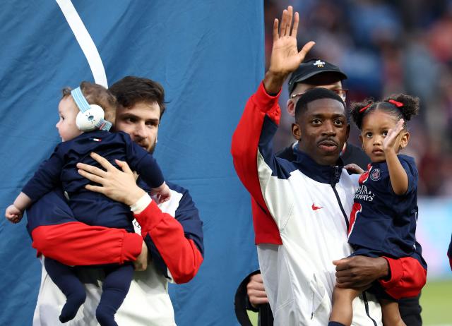 Paris Saint-Germain's French forward #10 Ousmane Dembele (R) and Paris Saint-Germain's Georgian forward #07 Khvicha Kvaratskhelia with their children wave to supporters ahead of the  French L1 football match between Paris Saint-Germain (PSG) and AJ Auxerre at The Parc des Princes Stadium in Paris on May 17, 2025. (Photo by FRANCK FIFE / AFP)