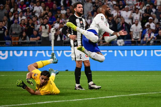 Lyon’s French forward #10 Alexandre Lacazette fights for the ball with Angers’ French goalkeeper #16 Melvin Zinga during the French L1 football match between Olympique Lyonnais (OL) and  SCO Angers at The Groupama Stadium in Decines-Charpieu, central-eastern France on May 17, 2025. (Photo by OLIVIER CHASSIGNOLE / AFP)